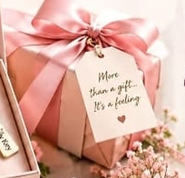 Blush gift box with a pink ribbon and message tag