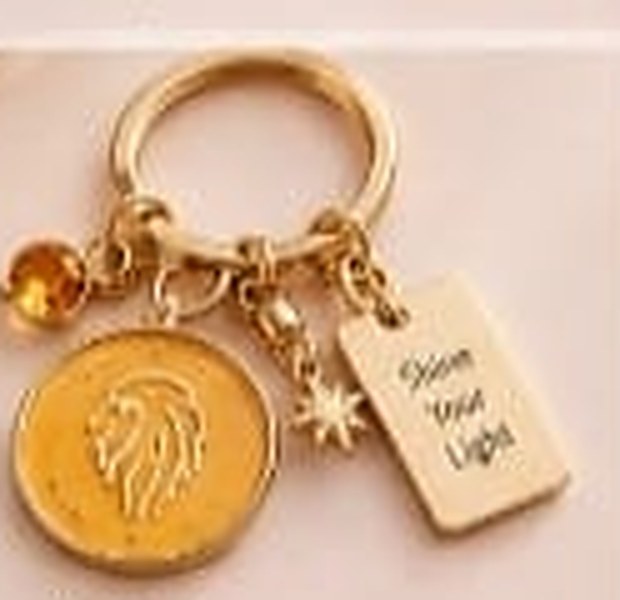 Leo zodiac keychain with a golden-yellow enamel disc